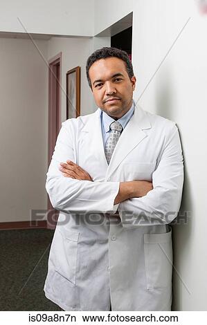 Mature doctor in hospital corridor, portrait View Large Photo Image Picture - Mature doctor in hospital corridor, portrait. Fotosearch