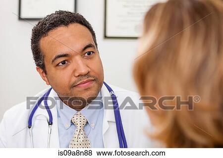 Mature doctor listening to patient View Large Photo Image Stock Photo - Mature doctor listening to patient. Fotosearch