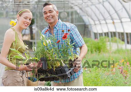 Mature man and mid adult woman shopping in garden centre, smiling View Large Photo Image Stock Image - Mature man and mid adult woman shopping in garden centre, smiling. Fotosearch