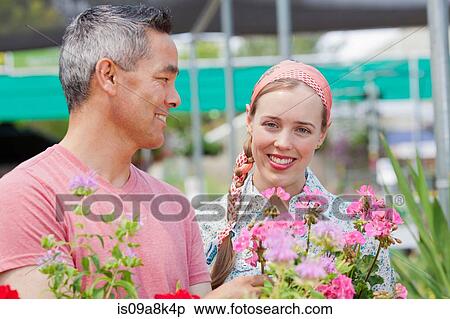 Mature man and mid adult woman shopping in garden centre, smiling View Large Photo Image Stock Photography - Mature man and mid adult woman shopping in garden centre, smiling. Fotosearch
