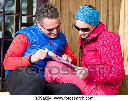 Mature man and young woman looking at map in ski resort View Large Photo Image Picture - Mature man and young woman looking at map in ski resort. Fotosearch