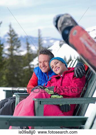 Mature man and young woman relaxing together in ski resort View Large Photo Image Stock Image - Mature man and young woman relaxing together in ski resort. Fotosearch
