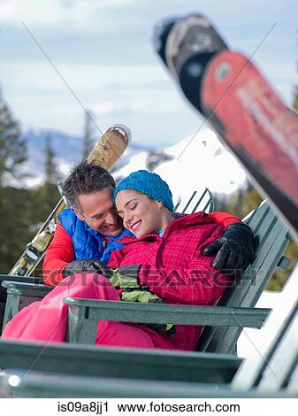 Mature man and young woman relaxing together in ski resort View Large Photo Image Stock Image - Mature man and young woman relaxing together in ski resort. Fotosearch