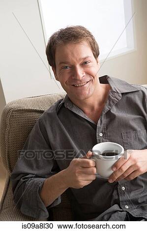 Mature man holding coffee View Large Photo Image Stock Image - Mature man holding coffee. Fotosearch