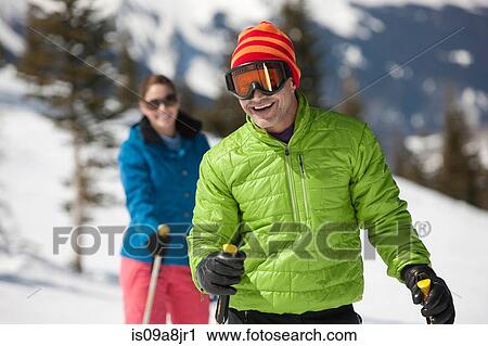 Mature man in skiwear holding ski poles, portrait View Large Photo Image Stock Image - Mature man in skiwear holding ski poles, portrait. Fotosearch