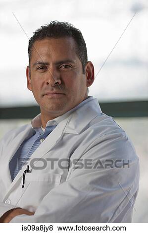Stock Photo - Mature man wearing lab coat, portrait. Fotosearch