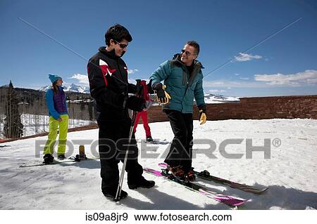 Mature man with ski instructor on ski slope View Large Photo Image Stock Photo - Mature man with ski instructor on ski slope. Fotosearch