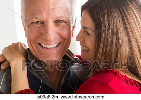 Picture - Mature woman and senior man hugging, close up. Fotosearch