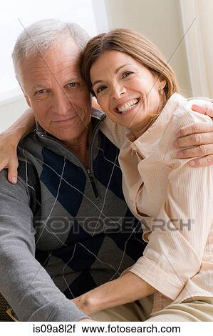 Stock Image - Mature woman and senior man hugging. Fotosearch