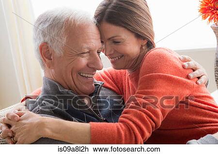 Stock Image - Mature woman and senior man hugging. Fotosearch