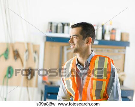 Mid adult construction worker smiling View Large Photo Image Stock Photo - Mid adult construction worker smiling. Fotosearch