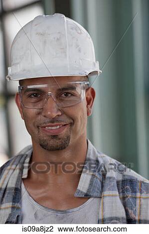 Mid adult construction worker wearing hard hat, portrait View Large Photo Image Stock Image - Mid adult construction worker wearing hard hat, portrait. Fotosearch