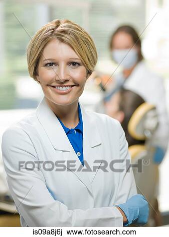 Mid adult dentist smiling, portrait View Large Photo Image Stock Image - Mid adult dentist smiling, portrait. Fotosearch