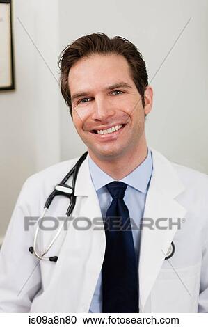 Mid adult doctor smiling, portrait View Large Photo Image Stock Image - Mid adult doctor smiling, portrait. Fotosearch