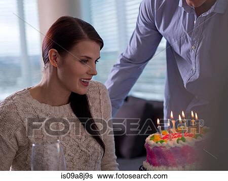 Mid adult man giving young woman birthday cake View Large Photo Image Stock Photograph - Mid adult man giving young woman birthday cake. Fotosearch