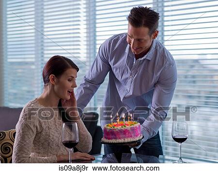 Mid adult man giving young woman birthday cake View Large Photo Image Stock Photography - Mid adult man giving young woman birthday cake. Fotosearch