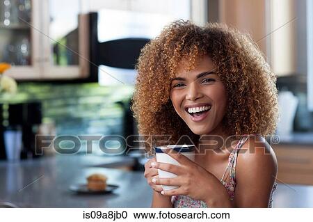Mid adult woman enjoying coffee in kitchen, portrait View Large Photo Image Stock Image - Mid adult woman enjoying coffee in kitchen, portrait. Fotosearch