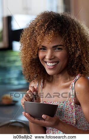 Mid adult woman holding breakfast bowl, portrait View Large Photo Image Stock Image - Mid adult woman holding breakfast bowl, portrait. Fotosearch