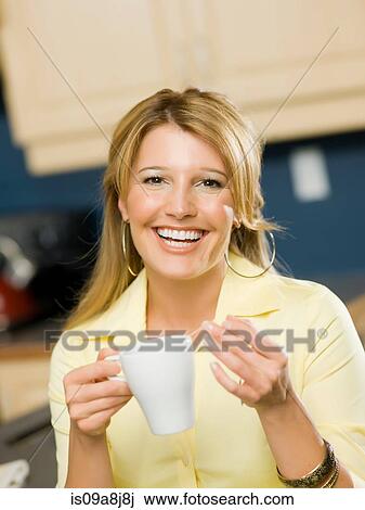 Mid adult woman holding cup and smiling, portrait View Large Photo Image Stock Image - Mid adult woman holding cup and smiling, portrait. Fotosearch