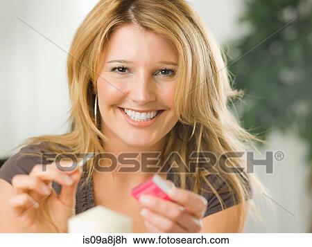 Mid adult woman lighting candle, portrait View Large Photo Image Stock Image - Mid adult woman lighting candle, portrait. Fotosearch