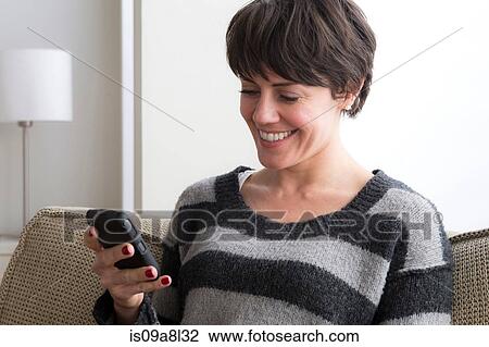 Mid adult woman using smart phone View Large Photo Image Stock Image - Mid adult woman using smart phone. Fotosearch