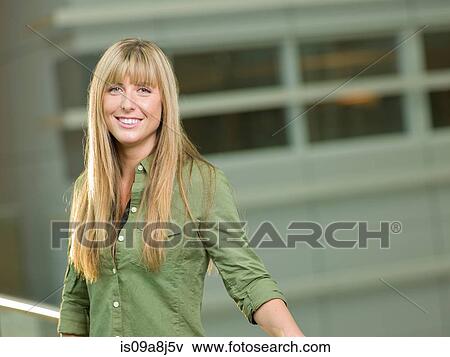 Mid adult woman wearing green shirt, smiling View Large Photo Image Stock Photo - Mid adult woman wearing green shirt, smiling. Fotosearch
