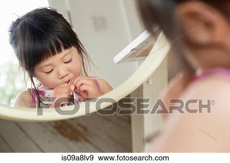 Mirror portrait of toddler fastening dress buttons View Large Photo Image Stock Photo - Mirror portrait of toddler fastening dress buttons. Fotosearch