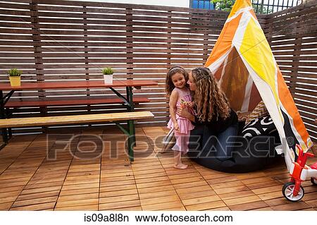 Mother and daughter by tent on patio View Large Photo Image Picture - Mother and daughter by tent on patio. Fotosearch