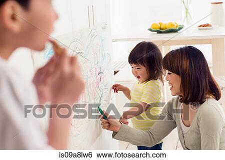 Stock Photograph - Mother and daughter having fun drawing. Fotosearch