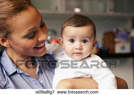 Stock Photo - Mother holding baby girl. Fotosearch