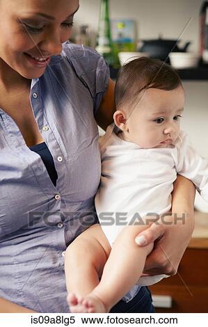 Mother holding baby girl View Large Photo Image Stock Photography - Mother holding baby girl. Fotosearch