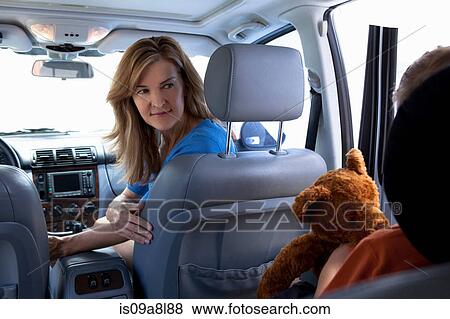 Mother turning around to child in car View Large Photo Image Stock Photo - Mother turning around to child in car. Fotosearch