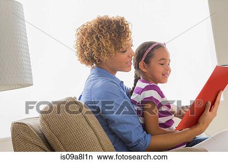 Mother with daughter reading book View Large Photo Image Picture - Mother with daughter reading book. Fotosearch