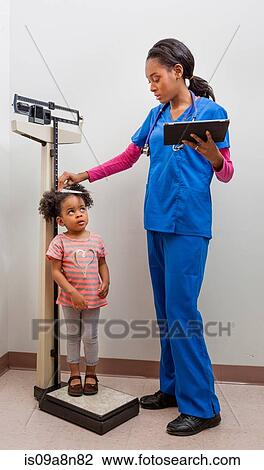 Nurse measuring height of young patient View Large Photo Image Stock Image - Nurse measuring height of young patient. Fotosearch