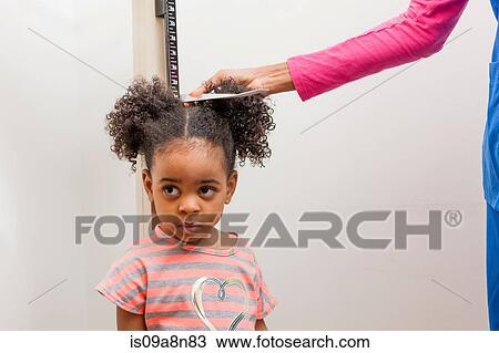 Nurse measuring height of young patient View Large Photo Image Stock Image - Nurse measuring height of young patient. Fotosearch