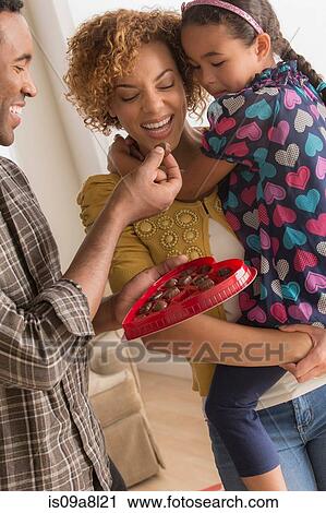 Parents and daughter with heart shaped chocolate box View Large Photo Image Stock Image - Parents and daughter with heart shaped chocolate box. Fotosearch