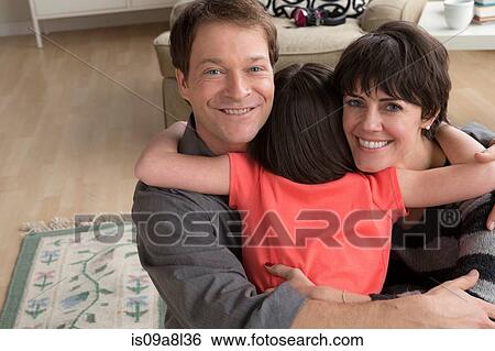 Parents hugging daughter View Large Photo Image Stock Photograph - Parents hugging daughter. Fotosearch
