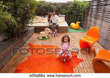 Parents relaxing outdoor with children playing on patio View Large Photo Image Stock Photography - Parents relaxing outdoor with children playing on patio. Fotosearch