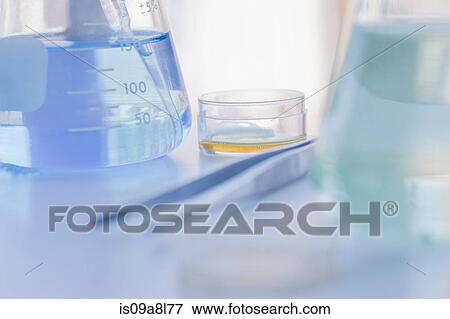 Stock Photo - Petri dish, tweezers and conical flask. Fotosearch