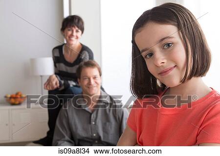 Portrait of girl with parents in background View Large Photo Image Picture - Portrait of girl with parents in background. Fotosearch