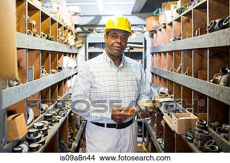 Portrait of man in plumbing stockroom with products View Large Photo Image Picture - Portrait of man in plumbing stockroom with products. Fotosearch
