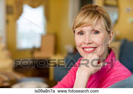 Stock Image - Portrait of mature woman at home. Fotosearch