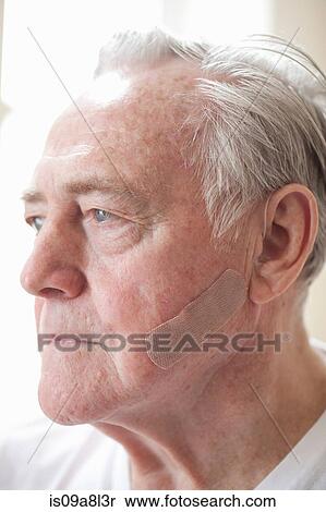 Portrait of senior man with adhesive plaster on cheek View Large Photo Image Stock Photography - Portrait of senior man with adhesive plaster on cheek. Fotosearch