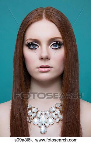 Stock Image - Portrait of woman wearing necklace. Fotosearch