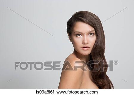 Stock Image - Portrait of woman with long brown hair. Fotosearch