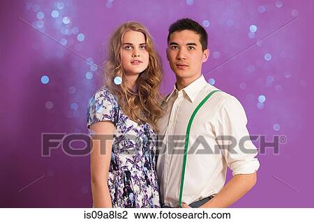 Stock Image - Portrait of young couple and glitter. Fotosearch