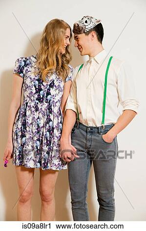 Stock Image - Portrait of young couple holding hands. Fotosearch