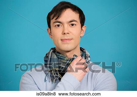 Portrait of young man wearing blue jumper and scarf View Large Photo Image Stock Photo - Portrait of young man wearing blue jumper and scarf. Fotosearch
