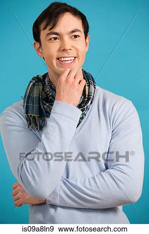 Portrait of young man wearing blue jumper and scarf View Large Photo Image Stock Photo - Portrait of young man wearing blue jumper and scarf. Fotosearch