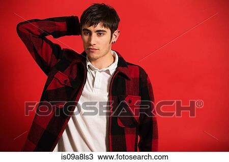Stock Image - Portrait of young man wearing checked shirt. Fotosearch